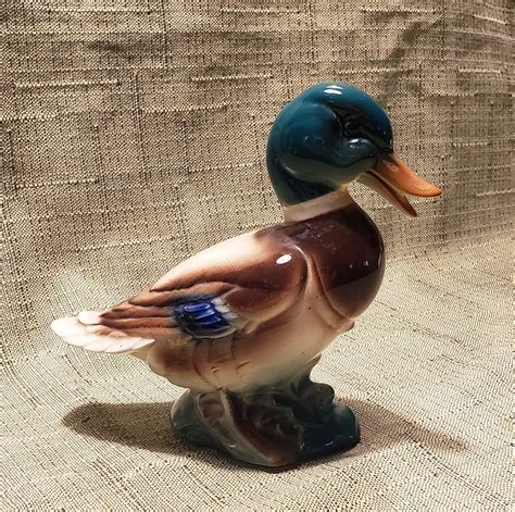 Please take a close look at pictures. . Porcelain mallard duck figurine